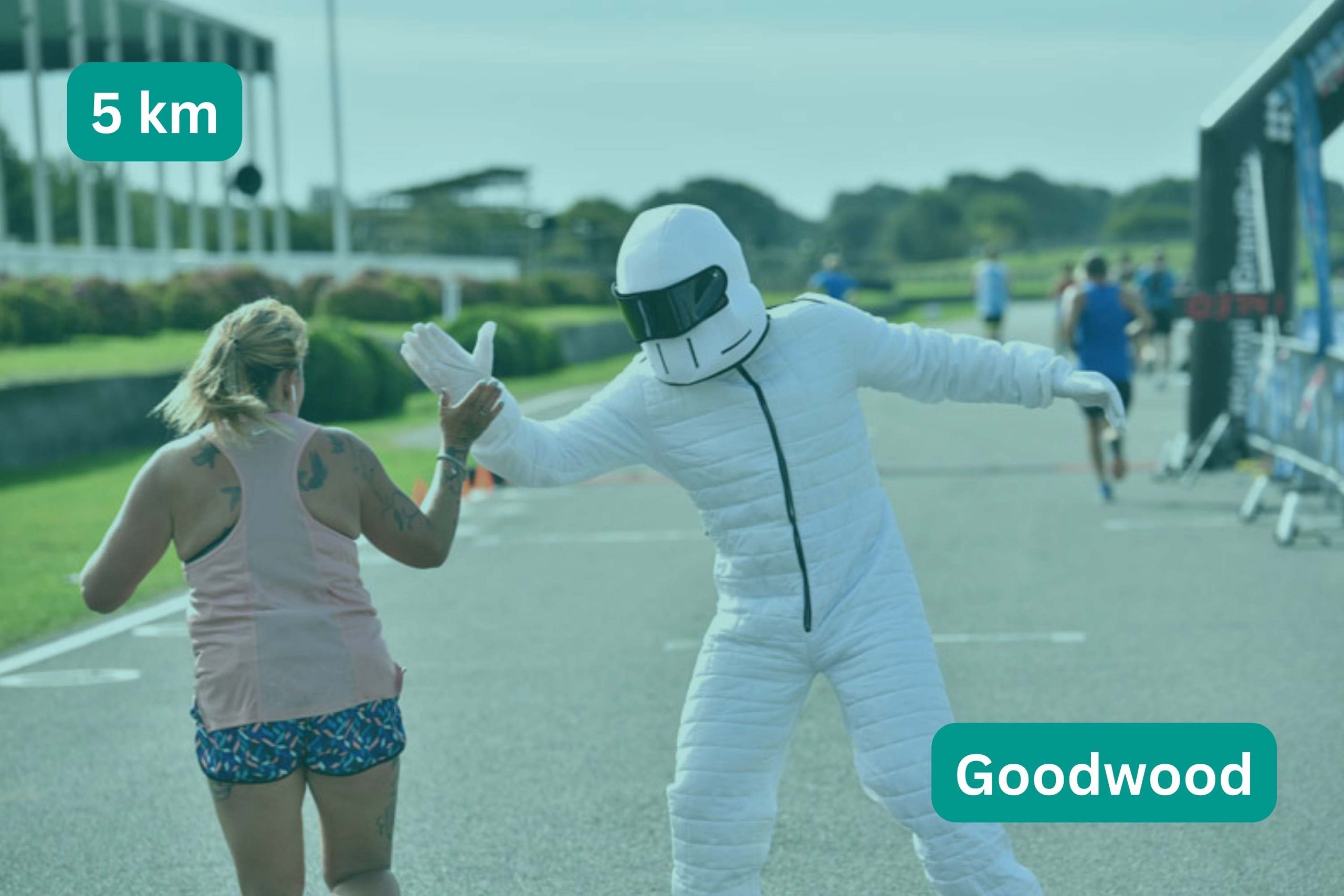 Woman giving the Stig a high five. title text 5 km Goodwood