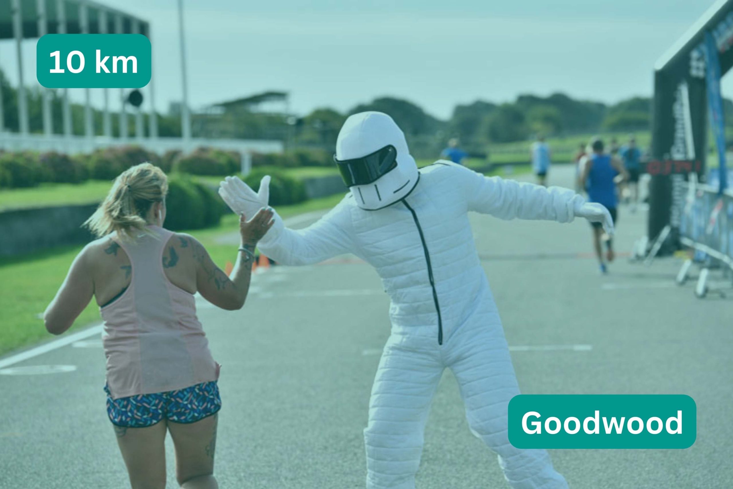 Woman giving the Stig a high five. title text 10 km Goodwood