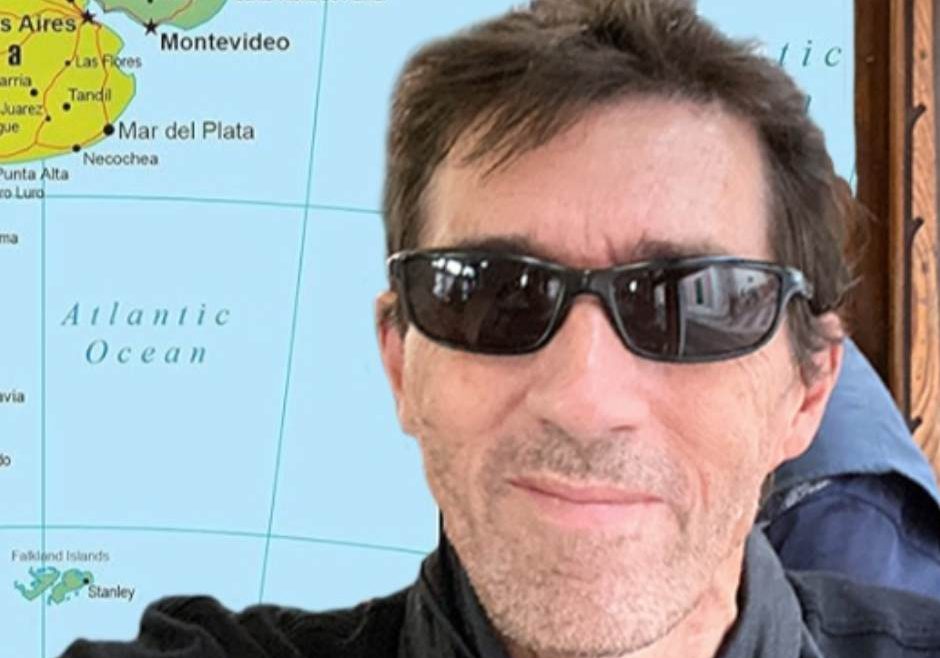 Picture of Steve standin in front of a map of south america